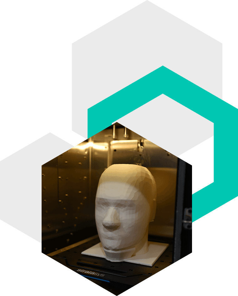 High-precision 3D printer creating detailed prototype parts at Dream Realization Lab